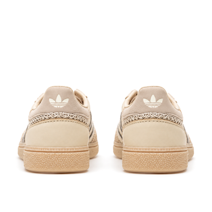 Straight rear pair of adidas Handball Spezial Cream White Beige showing the pale heel tabs and diagonal cross-stitch heel bands