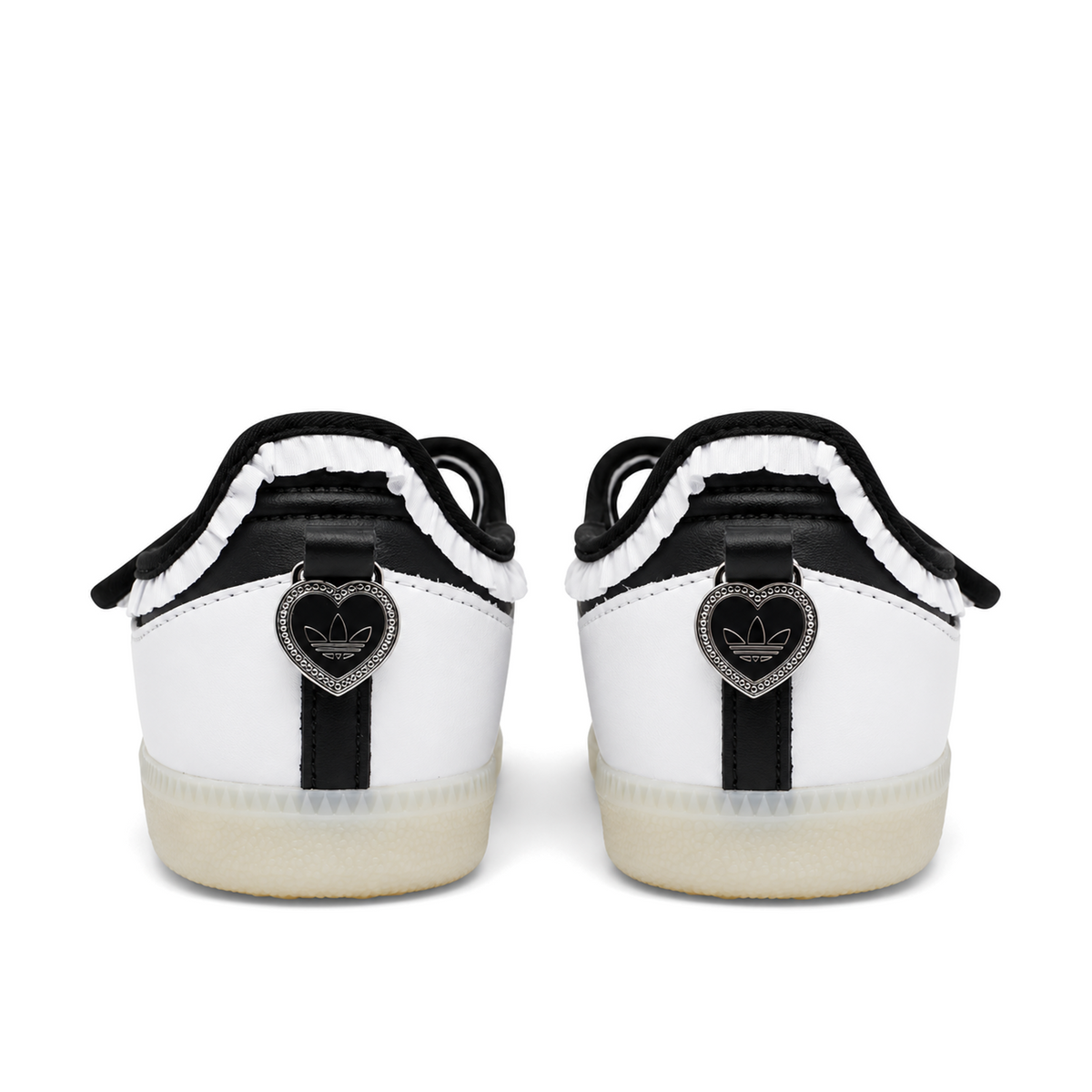 Straight rear view of adidas Samba Jane Ruffle shoes with black-centred silver heart heel charms and gathered white trim.