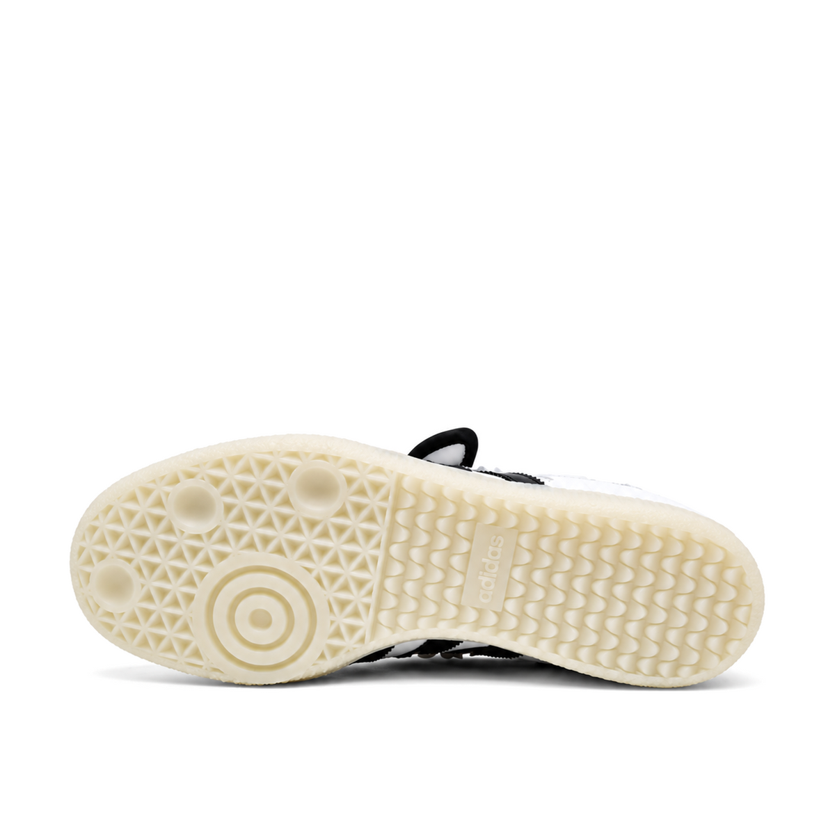 Pale outsole of the white and black Samba Jane Ruffle, with circular pivot rings on the left and repeating heel tread on the right.