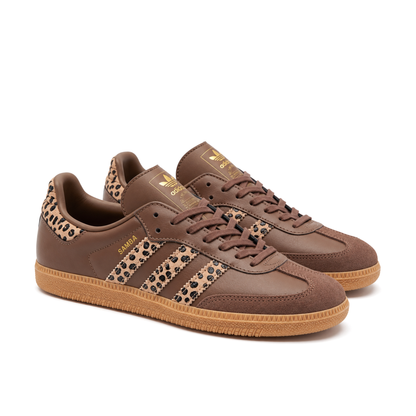 Front three-quarter pair of brown Samba OG sneakers, showing tonal laces, textured T-toes and leopard-print stripes.
