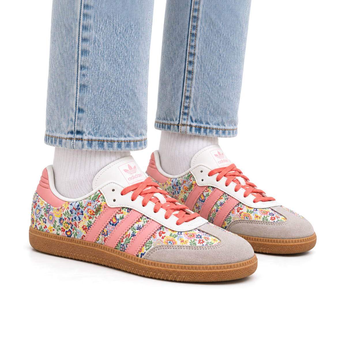 Adult wearing right-facing adidas Samba OG Liberty London Floral Embroidery shoes with light wash jeans and white socks