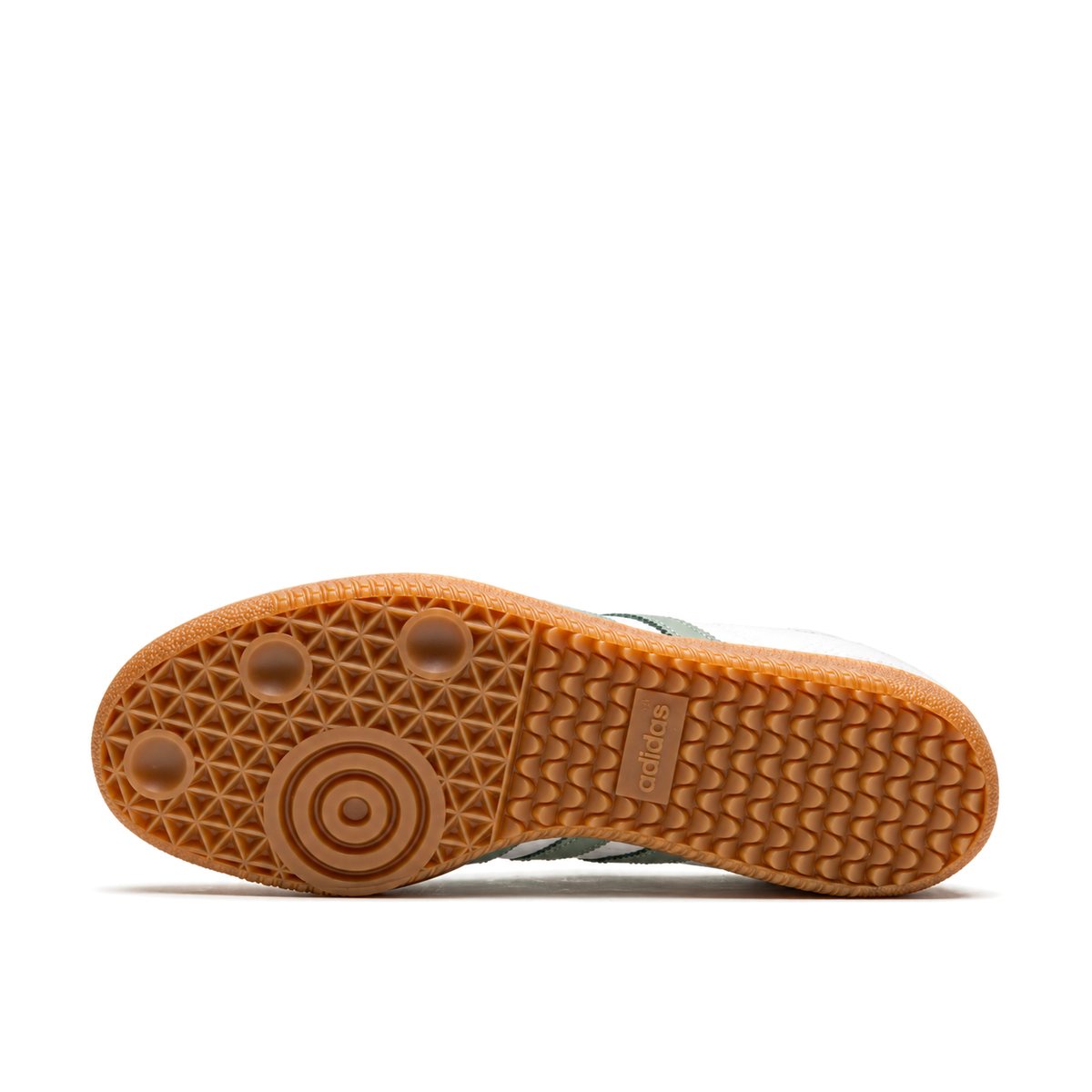 Horizontal gum outsole of the adidas Samba Silver Green with circular forefoot tread on the left and wave heel tread on the right