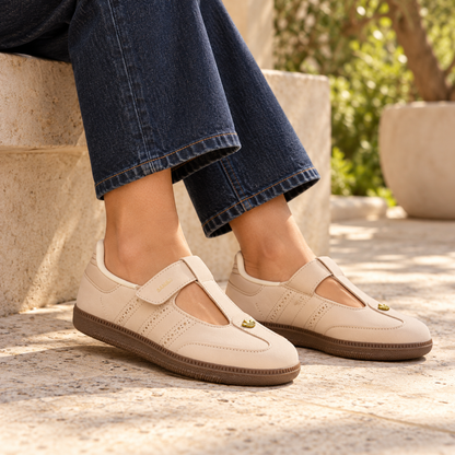 adidas Samba Jane Crystal Sand shoes styled with dark indigo jeans beside a limestone bench