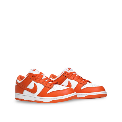 Nike Dunk Low sneakers with a white base and vibrant orange overlays, including the Swoosh logo, laces, and outsole.