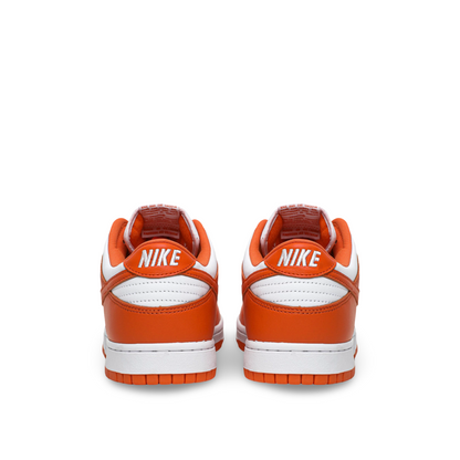 Back view of a pair of Nike sneakers with orange and white color scheme, featuring the Nike logo on the heel.